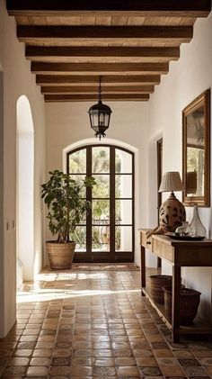 an entry way with tile flooring and potted plants