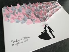 a wedding card with the silhouette of a bride and groom holding a heart shaped balloon