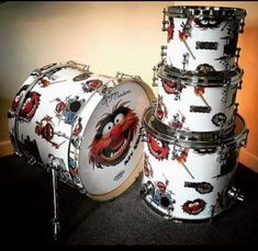 the drums are all white and have red dragon designs on their drum heads, as well as black hardware