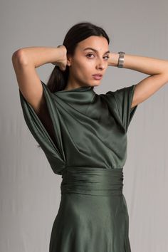 Word on the street is you want to stand out but still look chic. We’ve got you covered girl. The Fiore Dress is an asymmetrical dark sage green silk number, with a cowl neckline and ruched waist detailing. It means business on the right side and party on the left. It takes us 15 hours to make this dress. Check out the pricing transparency HERE. PLEASE ALLOW 1-3 BUSINESS DAYS FOR PRODUCTION Edgy Formal Dresses, Sage Green Bridesmaid Dresses Silk, Pear Clothes, Silk Wedding Guest Dress, Dark Green Dresses, Formal Wrap Dress, Simple Silk Dress, Sage Green Dark, Ethereal Fashion