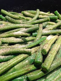 green beans are being cooked in a skillet with seasoning on them and sprinkled