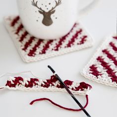 This quick and easy Candy Cane Coasters crochet pattern is the perfect holiday craft, and creates gorgeous Christmas themed coasters to add to your festive decor. Materials: To make a set of 4 coasters, you will need the following supplies: Size E/4 (3.5 mm) crochet hook. Knit Picks Comfy Worsted Weight Yarn: One Skein Ivory. One skein Hollyberry. Yarn Needle. Scissors. Each coaster measures: 4.5” X 4.5”. Skill Level: Advanced Beginner. Crochet Christmas Placemats, Christmas Candy Cane Decorations, Crocheted Coasters, Crochet Decorations, Coasters Crochet, Easy Candy, Crochet Hot Pads, Candy Cane Ornament, Crochet Xmas