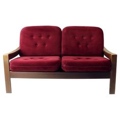 a red couch sitting on top of a wooden frame