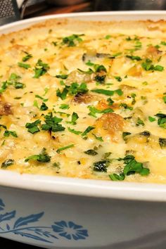 a casserole dish with spinach and cheese in it sitting on a table