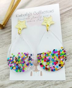 a pair of earrings with colorful stars on them