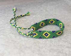 two braided bracelets sitting on top of a table