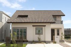 a white house with a brown tiled roof