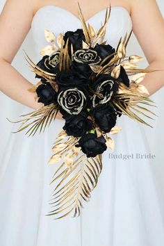 a bride holding a black and gold bouquet