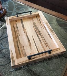 a wooden tray sitting on top of a glass table