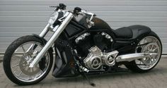 a black motorcycle parked in front of a garage door