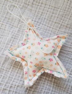 an ornament shaped like a star on a bed