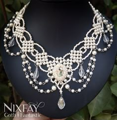 This handmade beaded necklace has a vintage style, making it a perfect accessory for a bride who wants to add a touch of timeless elegance to her wedding day look. The beads are intricately woven together, creating a delicate and intricate pattern that is sure to catch the eye. The necklace features a variety of beads in soft, muted tones, including ivory, champagne, and clear tones. These colors complement each other perfectly, creating a cohesive and harmonious design. The necklace also features a silver-toned clasp, adding a touch of sparkle and shine to the overall design. The beaded necklace is both lightweight and comfortable to wear, making it a great choice for a bride who wants to feel confident and stylish on her special day. Whether worn with a simple, understated gown or a more Bridal Beaded Jewelry, Victorian Pearl Necklace For Wedding, Victorian Beaded Wedding Necklace, Victorian Style Wedding Necklaces With Round Beads, Handmade Victorian Pearl Necklaces, Gothic Beaded Wedding Jewelry, Handmade Victorian Pearl Necklace, Handmade Baroque Necklace For Wedding, Handmade Baroque Wedding Necklace