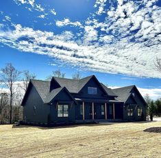 a large house sitting on top of a dry grass field