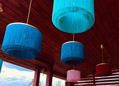 three blue and pink lamps hanging from the ceiling