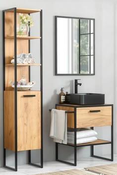 a bathroom with a sink, mirror and shelving unit next to the toilet area