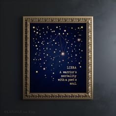 the zodiac sign leo on a dark blue background with gold trimmings is framed in an ornate gold frame