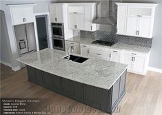 a large kitchen with white cabinets and granite counter tops on the island in front of an oven