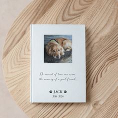 a book with a dog's photo on it sitting on a wooden table top