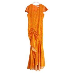 an orange dress hanging on a hanger