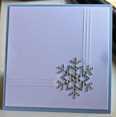 a card with a snowflake embellishment on it