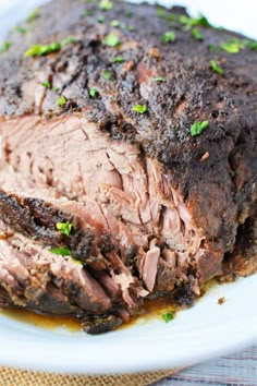 a close up of a meatloaf on a plate with garnishes