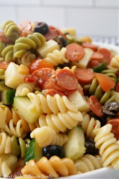 pasta salad with tomatoes, olives, and other vegetables