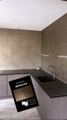 a kitchen with a sink and counter top next to a wall mounted faucet