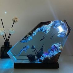 an aquarium is displayed on a table with flowers