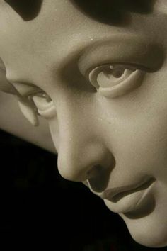 a close up view of a statue's face