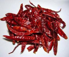 some red peppers are on a white plate