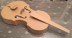 a violin made out of cardboard sitting on top of a table