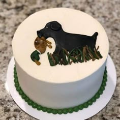 there is a cake with a dog and duck decoration on the top it sits on a plate