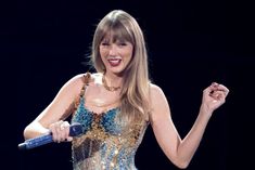 taylor swift performs on stage at an event