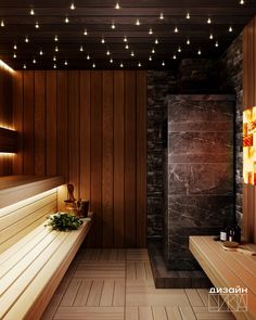 a wooden room with benches and lights on the wall above it, along with wood flooring