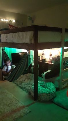 there is a bunk bed in the room with two kids on it and one has a hammock