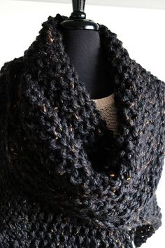 "Relax in front of your fireplace and add some warmth to your life or give this gift of love to a close one. This large shawl will keep you warm and cozy on a cold day or night. I knitted it from super chunky acrylic yarn in beautiful marled black color. AVAILABLE: Size L-XL US (8-12) Measurements: Side to side length: 84\" (213cm) without tassels Top to bottom length: 46\" (117cm) without tassel The flower brooch is NOT INCLUDED and sold separately here - https://www.etsy.com/listing/216901033 Black Wool Shawl For Winter, Black Wool Winter Shawl, Warm Black Scarves For Fall, Warm Black Scarf For Fall, Cozy Knitted Shawl For Fall, Cozy Knit Shawl For Winter, Cozy Black Shawl One Size, One Size Cozy Black Shawl, Cozy Black One-size Shawl