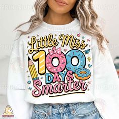 a woman wearing a white sweatshirt with the words little miss 100 days smarter on it