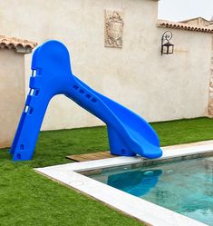 a blue slide sitting next to a swimming pool