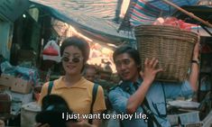 a man and woman carrying a basket on their shoulders in an outdoor market with the caption, i just want to enjoy life