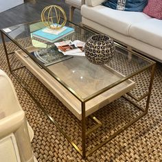 a living room with a couch, coffee table and other items on the carpeted floor