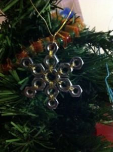 a snowflake ornament hanging from a christmas tree