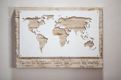 a wooden sign with a world map on it that says there is no place like home