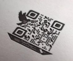 a close up of a qr code on a piece of paper with an image of a bird