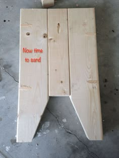 a wooden sign that says now time to sand