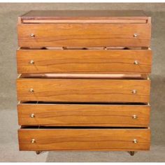 a wooden dresser with four drawers on it