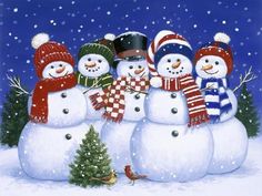 a group of snowmen standing next to each other in front of a christmas tree