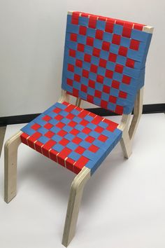 a blue and red chair sitting on top of a white floor