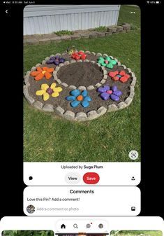 an image of a flower garden made out of rocks and flowers in the middle of it