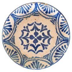 a blue and white plate with designs on it