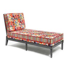 an upholstered chaise lounge with colorful fabric